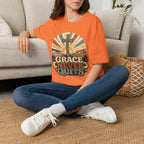 Christian T-Shirt — "Grace Never Quits" Retro Cross Sunrise Tee